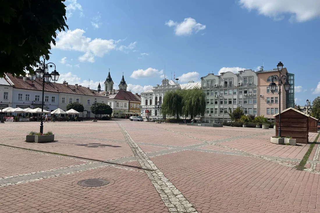 Belebter Stadtplatz mit Cafés und Menschen in einem Neuköllner Kiez